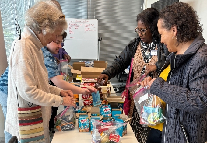 volunteers assemble snack bags